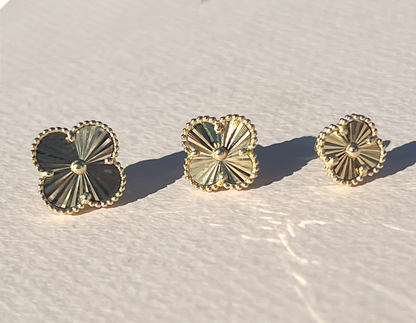 Gold sunburst clover earrings