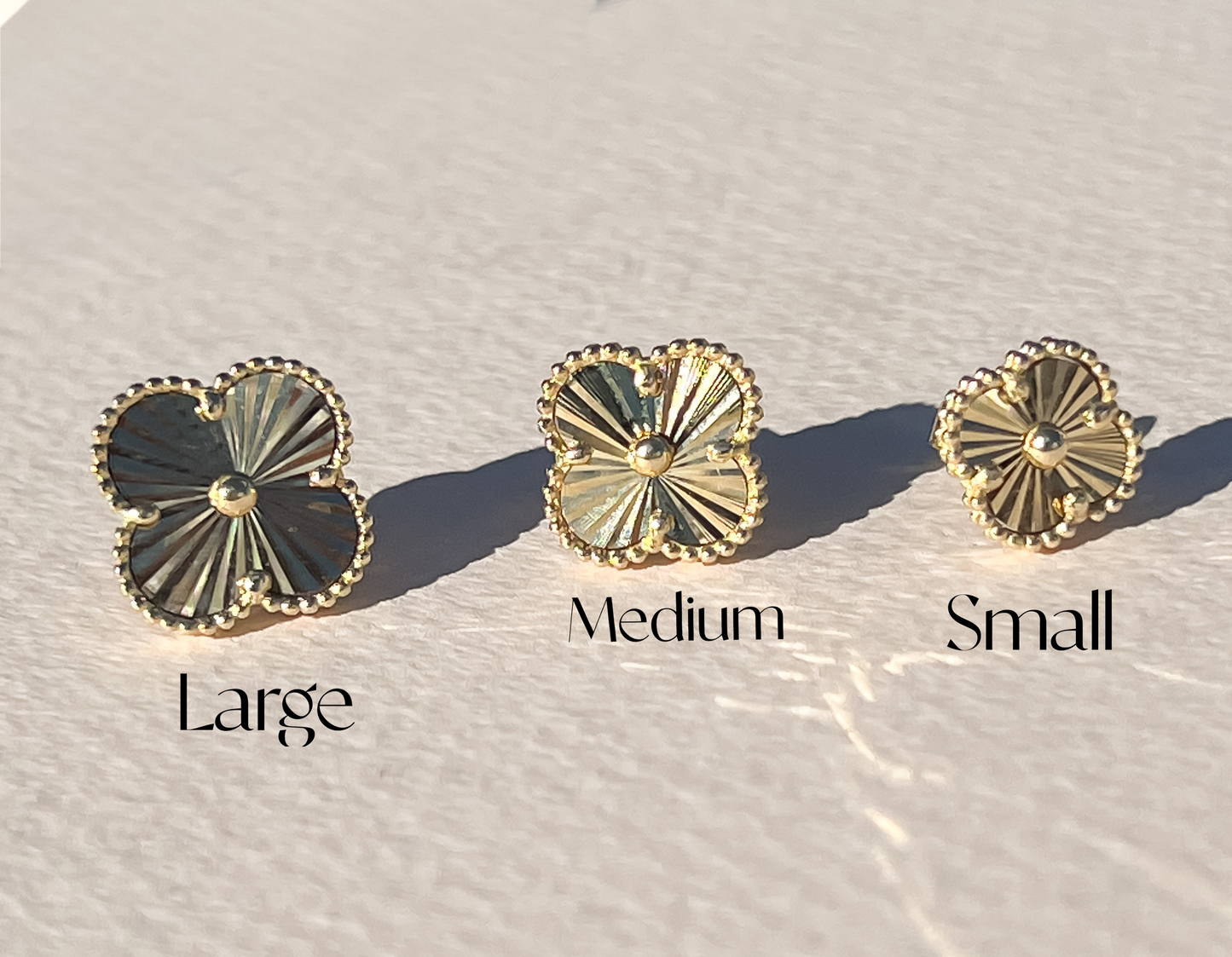 Gold sunburst clover earrings